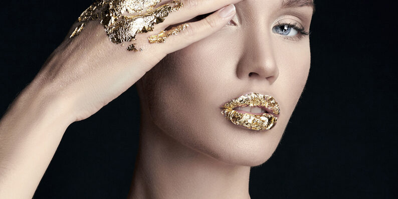 sexy Blonde young woman in golden foil
